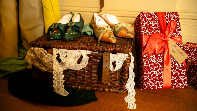 A case with clothes and a wrapped Christmas present sit in the corridor at Ickworth